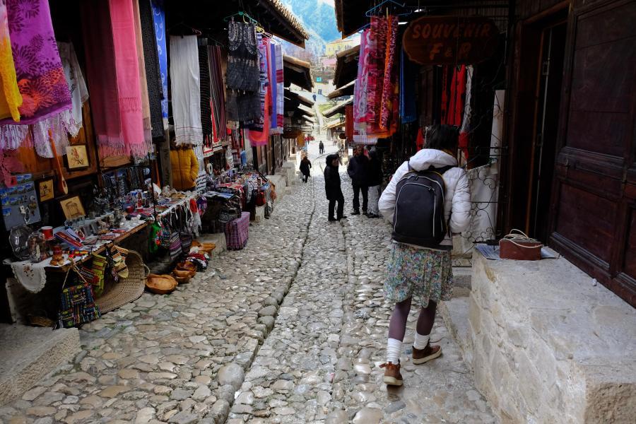 Pezana Rexha walking the bazaar street on which she is renovating six shops ©Chris Welsch